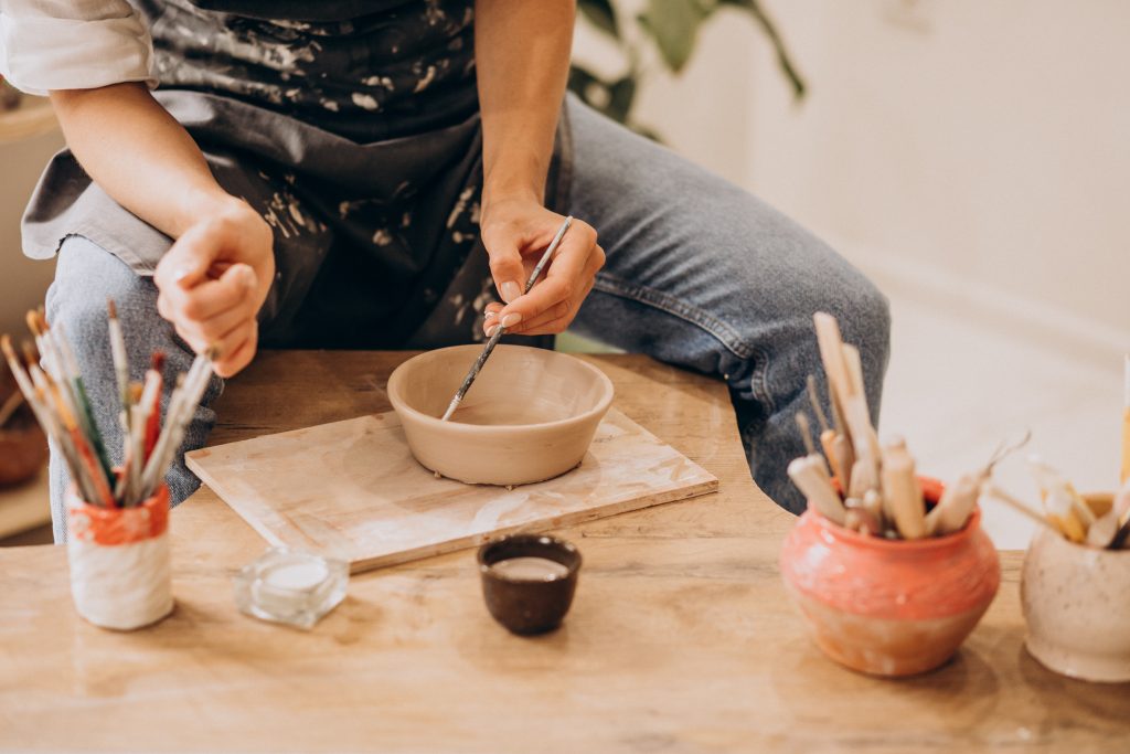Adults kidulting at pottery class